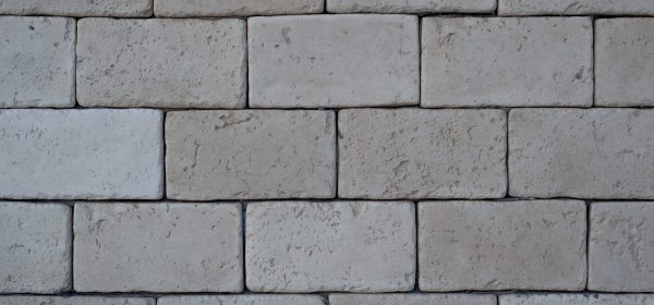 Brickwork from gray, large bricks close-up, outside.