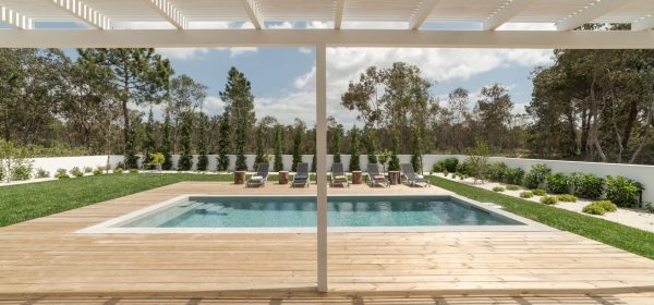 Modern house with garden swimming pool and wooden deck