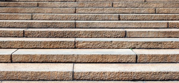 Stone staircase. Long stairs background. Light brown color outdoors stairway detail, closeup view